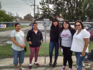 Kim Wasserman, right, and other Little Village residents with the diesel air monitor.